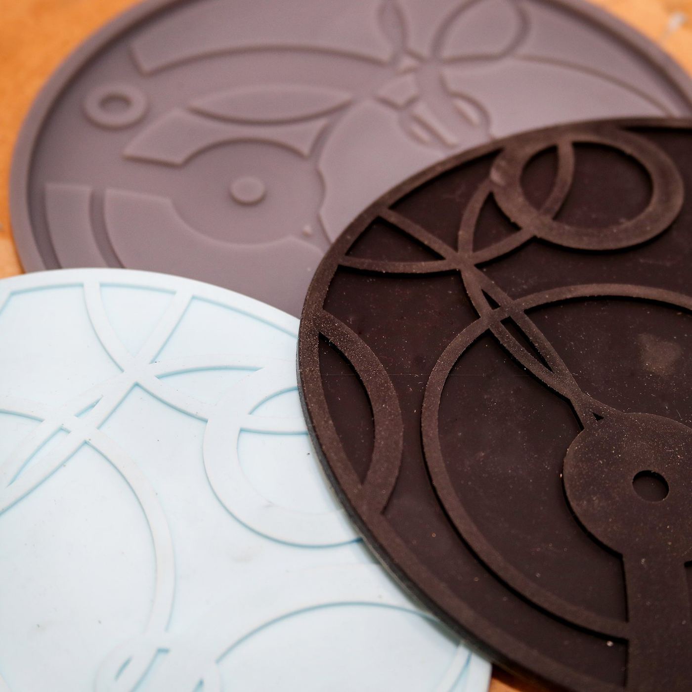 Finished cast silicone parts with relief detail.