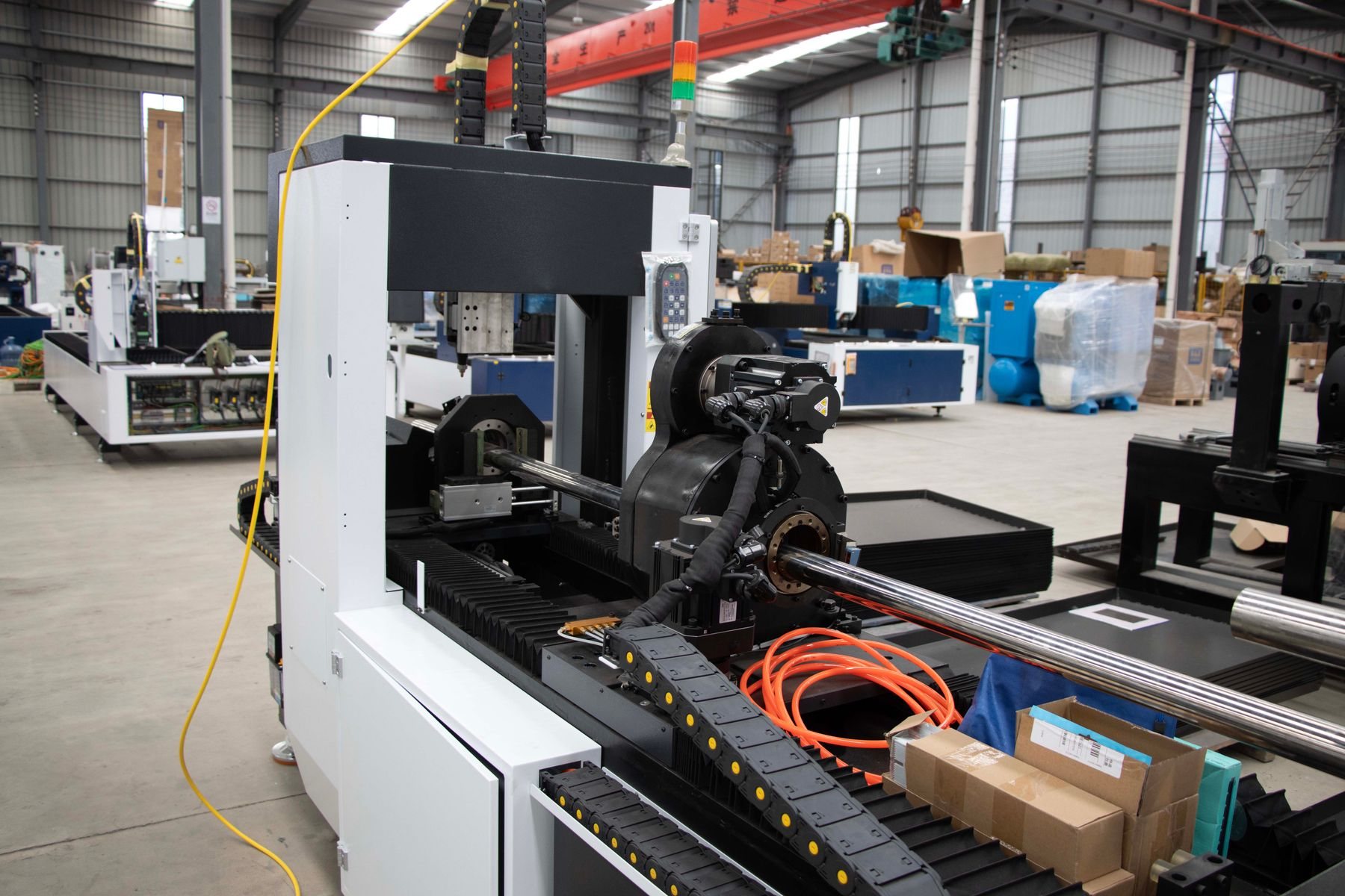 Modern sheet-metal fabrication line with CNC laser cutting.
