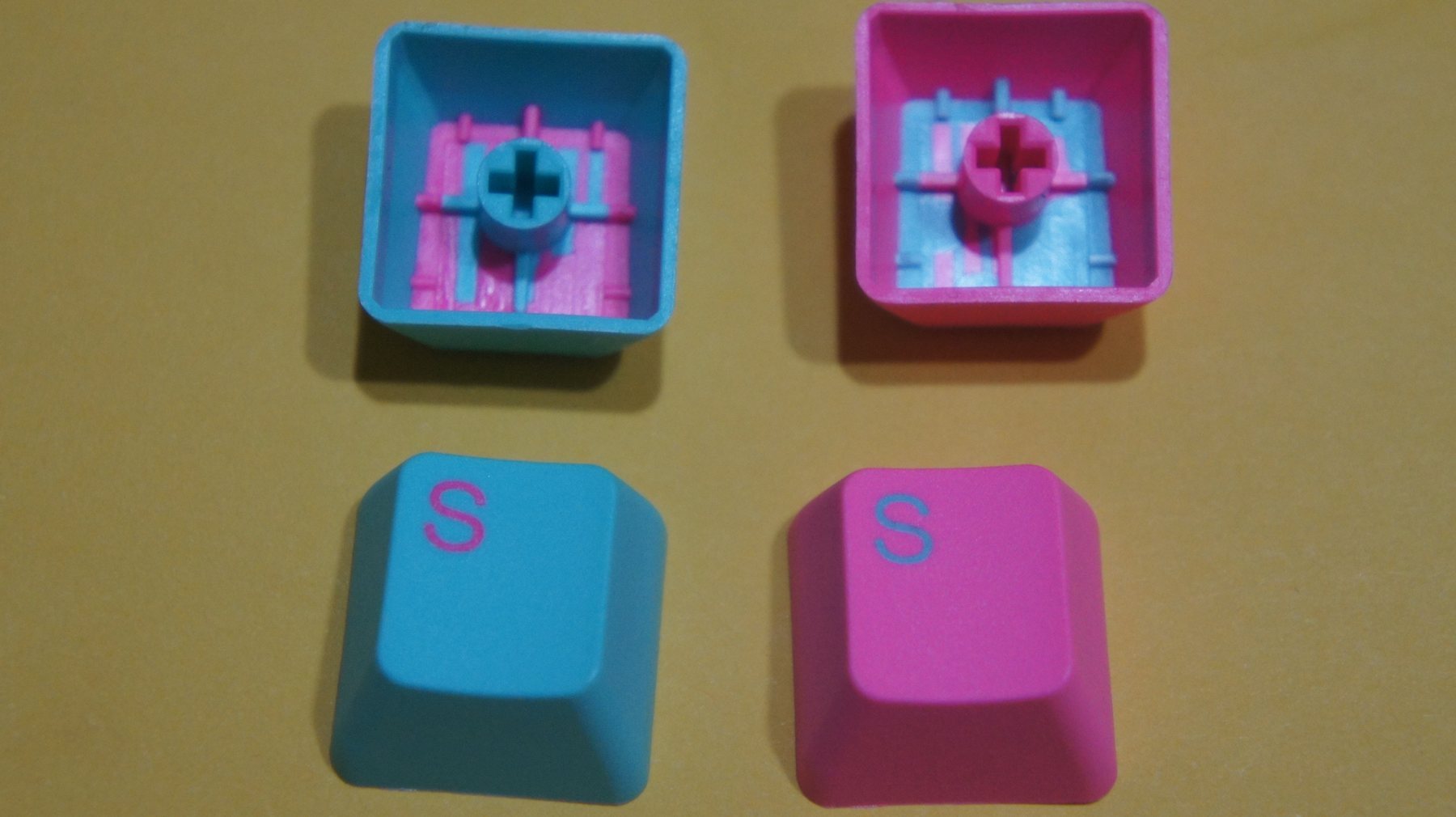 Two-shot moulded keycaps: a second material moulded through the first.